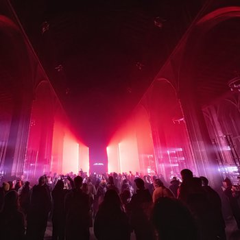 Crowds in a church with red lighting