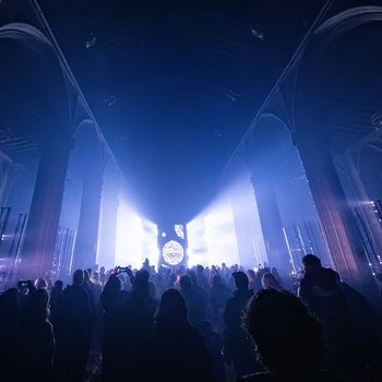 Crowds in a dark church with blue lighting