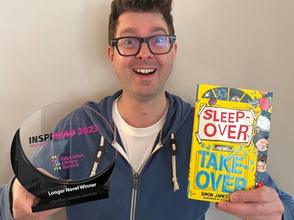 Author Simon James Green holds up the Inspiread trophy and his book sleepover takeover