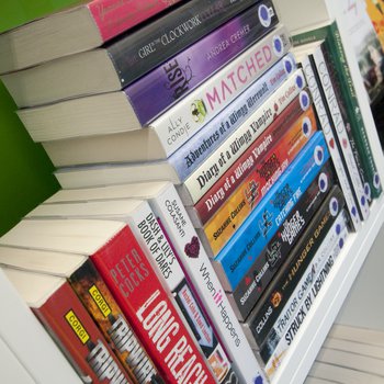 Library books stacked on a shelf