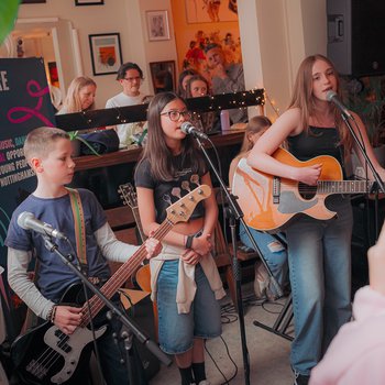 Young people playing musical instruments in a bar