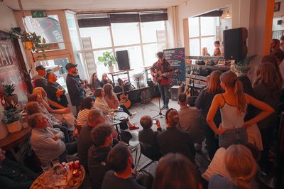 A room full of people watching a music performance