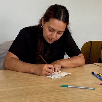 Person drawing in a handmade Zine