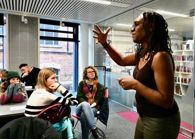 Presenter at front of a poetry workshop.