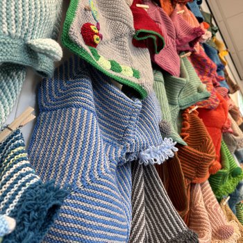 Knitted and crocheted Story Snugglers on the gallery wall