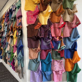 A wall of Story Snugglers, hundreds are on display.