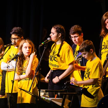Able Orchestra members singing and playing musical instruments