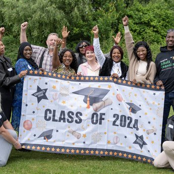 Access course group celebration with banner class of 2024