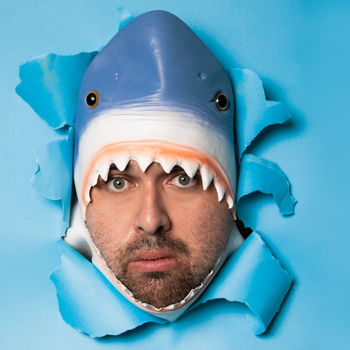 A person wearing a hat shaped like a shark.