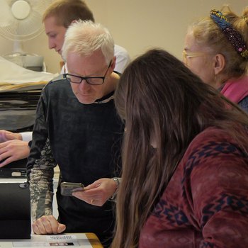 Visitor viewing AR content code via a smartphone