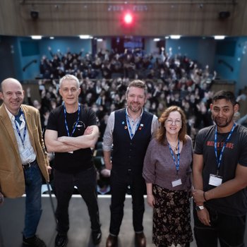 A group of authors stood on stage