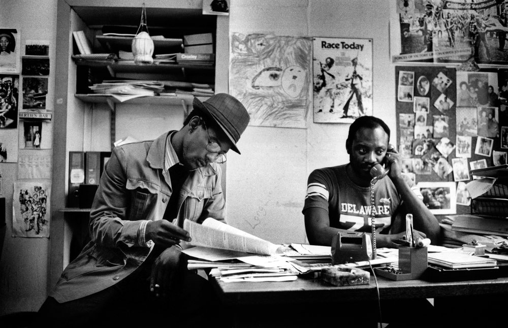 Description – Linton Kwesi Johnson and Darcus Howe in the office of the Race Today newspaper in 1979
