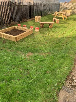 Bilsthorpe library garden showing lawn area planters and garden furniture