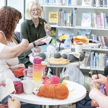 Group of happy ladies in the library during knit and natter session