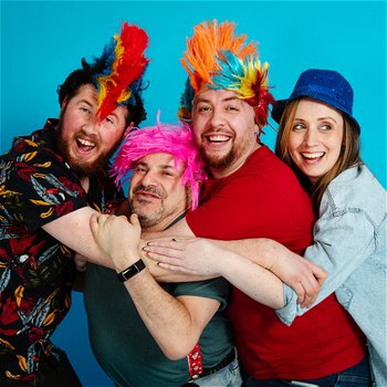 Four people wearing colourful feathers stood against a blue background.