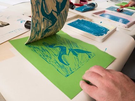 Hands showing Lino Printing