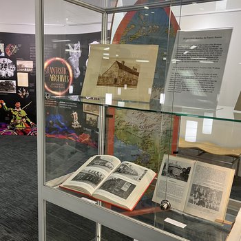 Glass cabinet with books on display and the Fantastic Archives pop-up exhibition at Worksop Library