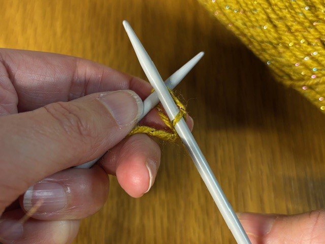 Photo of knitting second stitch being pulled through first