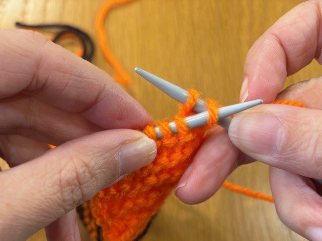 Right-hand knitting needle through the far right stitch on the left needle