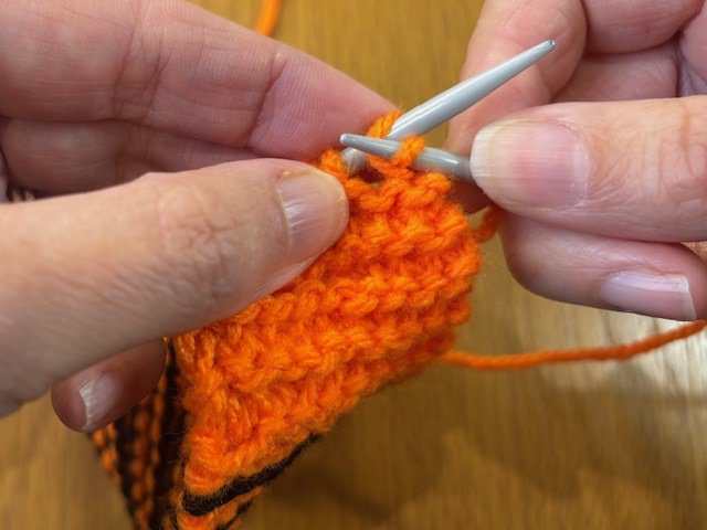 One knitting stitch brought over another.