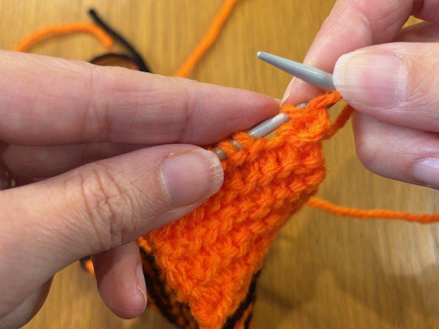 Slipping a stitch off a knitting needle