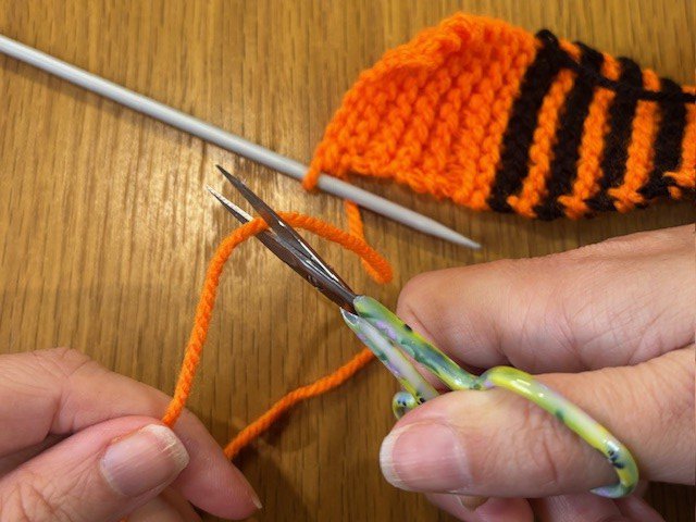 Scissors cutting yarn