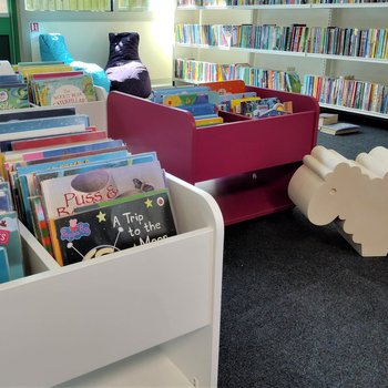 Improved childrens area, showing kinder boxes filled with picture books and model sheep