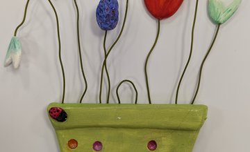 Green clay vase with coloured spots and clay flowers
