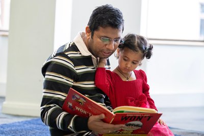 Comp parent children child reading books Mansfield library 2025 (9).jpg