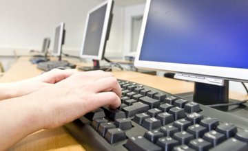 hands typing on keyboard in front of a computer screen