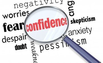 a range of words with a magnifying glass picking out the word confidence magnified