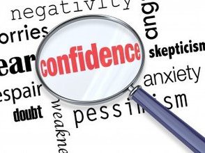 a range of words with a magnifying glass picking out the word confidence magnified