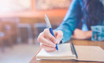 Person writing in notebook