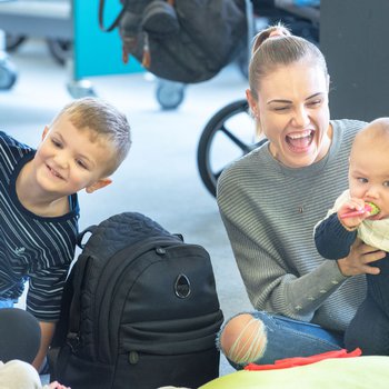 Mother holding her baby and laughing