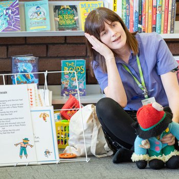 Library staff member singing Dingle Dangle Scarecrow at a session