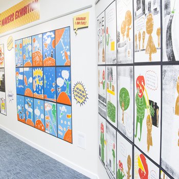 Gallery wall displaying colourful cartoon prints