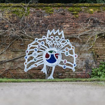 A metal casted peacock sculpture