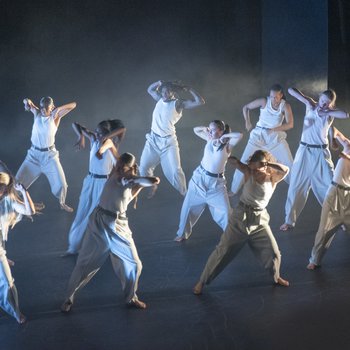 hip hop dancers on stage in white outfits