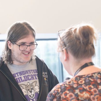 A student talking to a tutor about GCSE results.