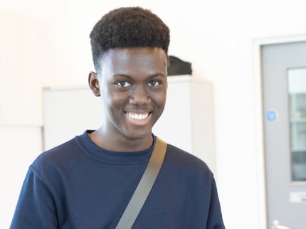 smiling young male college student with exam results