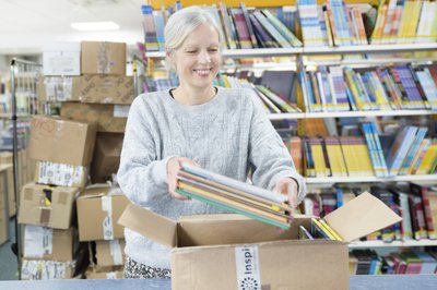 A person takes books out of a box