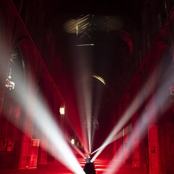 A church interior lit up with red lights.