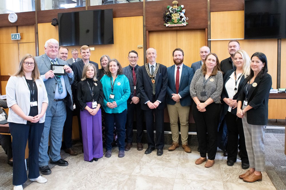 Members of Inspire learning team holding the Ofsted 'Good' plaque, with Councillors John Smith and Richard Butler