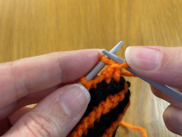 Image of a knitting stitch pulled through another stitch