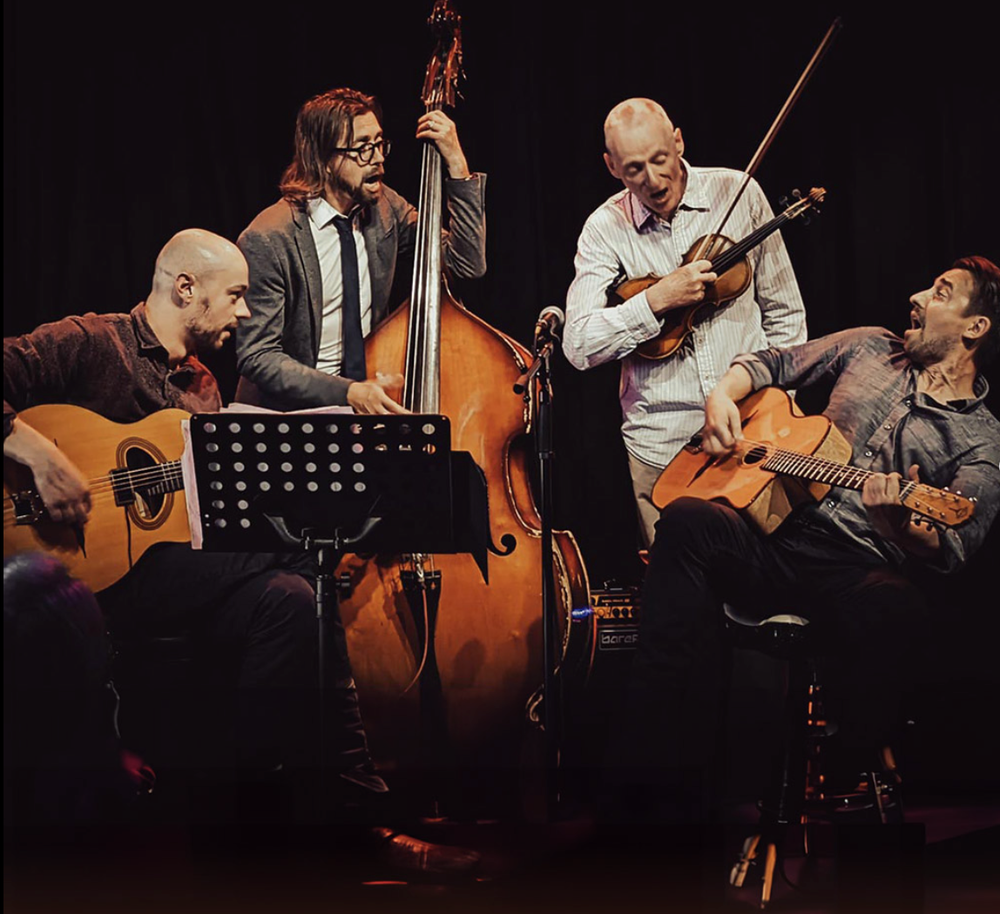 The 4 members of Djanco with 2 guitars, bass violin