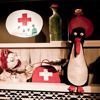 A penguin puppet sitting on a shelf