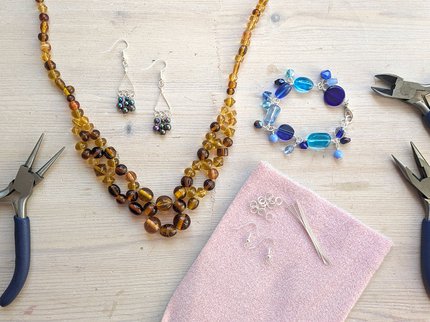 Jewellery and tools laid out on table