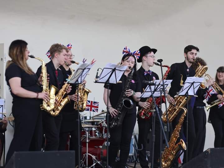 Red Hot Band performing on stage at Berry Hill Park Mansfield on 7th May 2023.