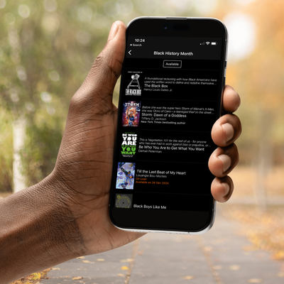 A hand holding a smartphone with BorrowBox's Black History Month collection shown