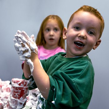 children enjoying getting messy with foam